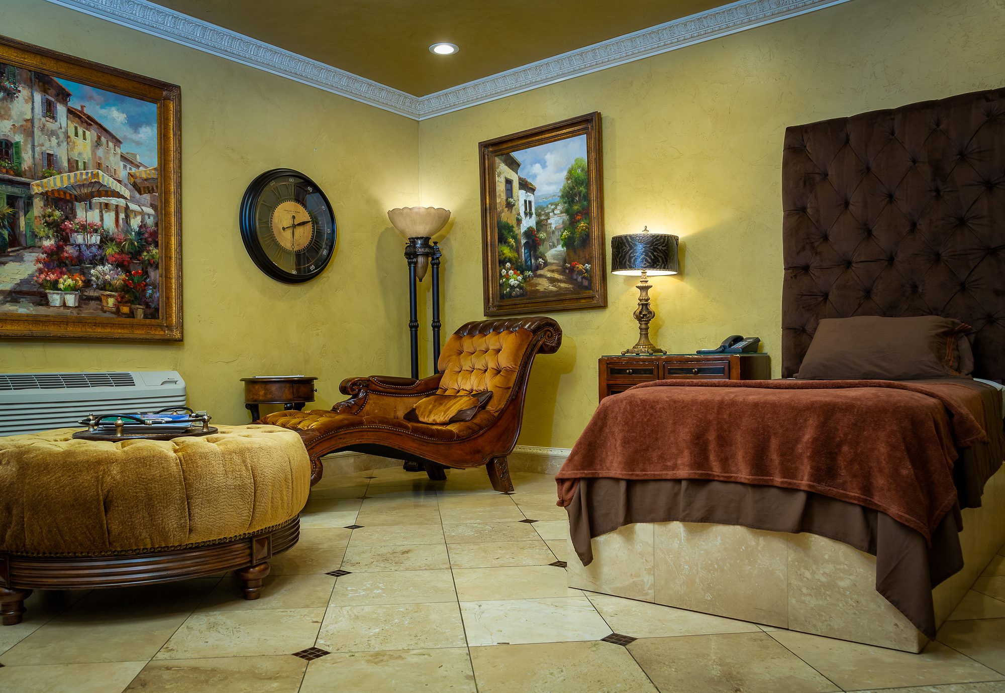 The private patient suite at Tulsa Surgical Arts with a bed, chaise, and lamp-lit seating